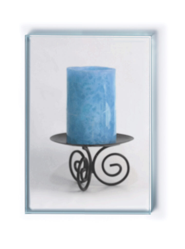 A blue candle on an ornate black metal holder with curled details set behind privacy glass.